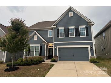 Charming two-story home with a two-car garage and manicured landscaping at 3022 Burnello Ct, Iron Station, NC 28080