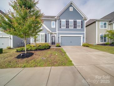 Charming two-story home with a well-maintained lawn, inviting curb appeal, and a two-car garage at 3022 Burnello Ct, Iron Station, NC 28080