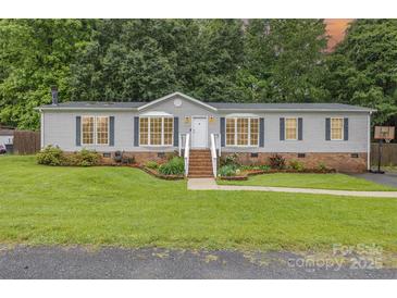 Charming single-story home with well-maintained lawn, brick foundation and inviting front porch at 403 Carpenter Parker Ln, Rock Hill, SC 29730