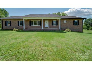 Charming single-story brick home with a well-manicured front yard and covered porch at 55 Dixie Dr, Taylorsville, NC 28681