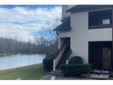 A beautiful building exterior with a well-maintained lawn and scenic water view at 5718 Dockside Dr, Charlotte, NC 28227