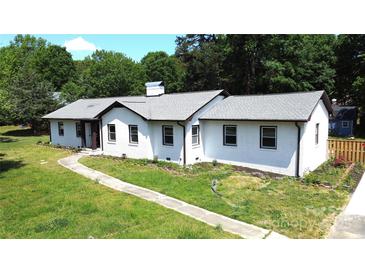 Charming single-story home with fresh exterior paint, walkway, and mature landscaping at 7101 City View Dr, Charlotte, NC 28212