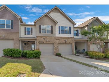 Inviting townhome showcasing manicured lawns, driveways leading to garages, and a pleasing facade on a sunny day at 8031 Scarlet Oak Ter, Indian Land, SC 29707