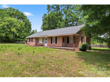 Classic single-story brick home with black shutters and a covered porch at 804 Gw Broome Rd, Monroe, NC 28112