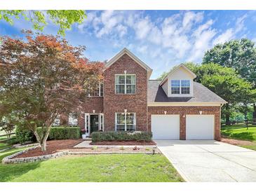 Charming two-story brick home with a landscaped yard and a two-car garage at 9157 Snow Hill Ct, Charlotte, NC 28269