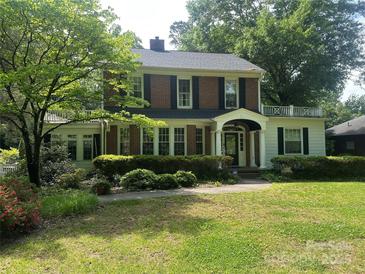 Charming two-story brick home with black shutters, a manicured lawn, and lush landscaping at 1139 S Belvedere Ave, Gastonia, NC 28054