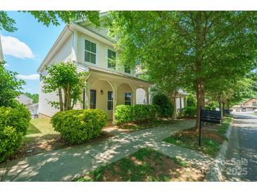 Charming two-story home with a welcoming front porch and mature landscaping at 11530 Galashiels Dr, Huntersville, NC 28078
