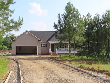 Charming single-Gathering home featuring a covered front porch and an attached two-car garage with gravel driveway at 153 Mason Tanner Ct, Rock Hill, SC 29730