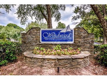 Stone community sign with flower bed below and featuring 'Windward' and 'Private Community' on a blue background at 19901 Henderson Rd # M, Cornelius, NC 28031