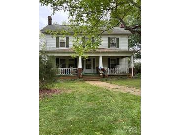 Charming two-story home with a covered front porch and classic architectural details at 208 E Main St, Cleveland, NC 27013