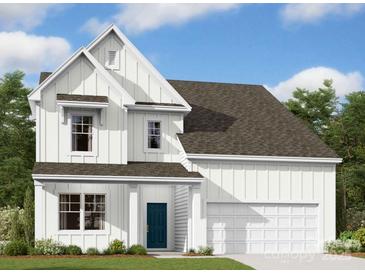 Charming two-story home with white siding, a blue front door, and an attached two-car garage at 3060 Ballenger St, Kannapolis, NC 28027