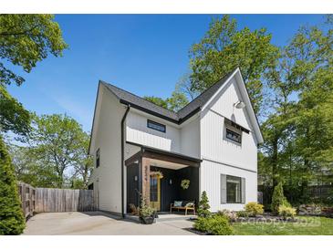 Modern farmhouse exterior with a covered porch, white siding, and well-maintained landscaping at 324 Elm St, Belmont, NC 28012