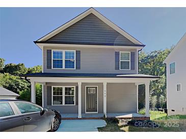Charming two-story house featuring a welcoming front porch and a well-maintained exterior at 668 Smith St, Kannapolis, NC 28083