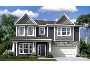 Charming two-story home showcasing stone accents, a covered entry, and a spacious two-car garage at 9930 Emerson Glen Dr, Kannapolis, NC 28027