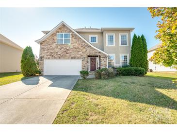Charming two-story home featuring a stone facade, well-manicured lawn, and a two-car garage at 2441 Chatham Dr, Fort Mill, SC 29707