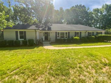Charming single-story home featuring a well-manicured lawn and inviting curb appeal at 5013 Prestwick Ln, Charlotte, NC 28212