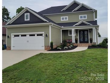 Charming two-story home with a two-car garage, lovely landscaping, and a welcoming front entrance at 5118 Regents Park Dr, Hickory, NC 28602