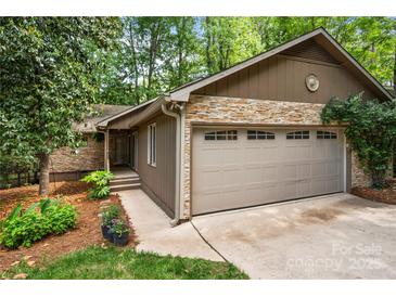 Charming home exterior featuring a stone facade, two-car garage, and well-maintained landscaping at 7 Turtle Ln, Clover, SC 29710
