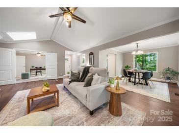 Bright living space with hardwood floors, a comfortable sofa and easy access to the dining area at 7 Turtle Ln, Clover, SC 29710