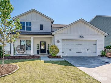 Charming two-story home features a well-manicured lawn, a cozy front porch, and a convenient two-car garage at 2678 Wedgewood Ct, Denver, NC 28037