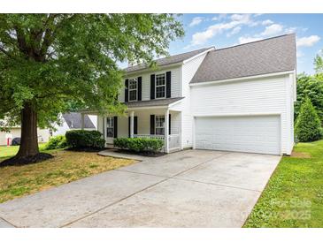 Charming two-story home with a well-manicured lawn, attached garage, and inviting front porch at 3312 James Rd, Charlotte, NC 28215
