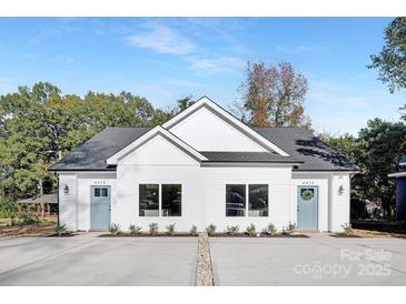 Charming duplex with modern farmhouse appeal, boasting a symmetrical facade and inviting curb appeal at 3314 & 3316 Cedarhurst Dr, Charlotte, NC 28269