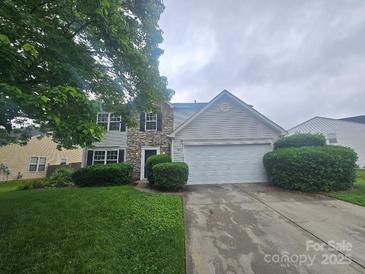 Charming two-story home with a stone-accented facade, attached garage, and well-kept front lawn at 3912 Laurel View Cir, Indian Trail, NC 28079