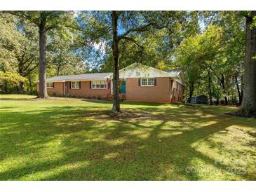 Charming brick ranch-style home with large front yard and mature trees providing ample shade at 709 Plantation Rd, Lancaster, SC 29720