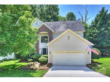 Charming two-story home featuring an attached garage and well-manicured landscaping, flag out front at 7833 Taymouth Ln, Charlotte, NC 28269