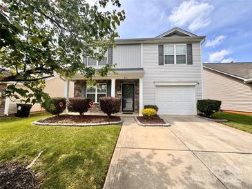 Charming home featuring manicured lawn, lovely shrubs, and a covered front porch at 815 Fescue Ct, Charlotte, NC 28216