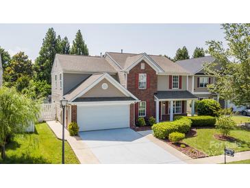 Charming two-story home with red shutters, attached two-car garage, and well-manicured front lawn at 10815 Mountain Springs Dr, Charlotte, NC 28278