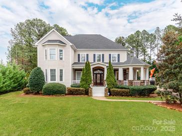 Beautiful two-story home with a well-manicured lawn and charming front porch at 123 Yellow Jacket Cir, Mooresville, NC 28117