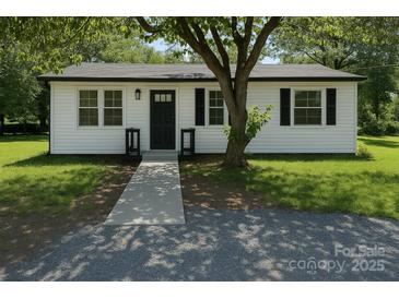Charming single-story home with white siding, black accents, and a well-maintained front yard and walkway at 1401 Woodman Hall St, Shelby, NC 28152