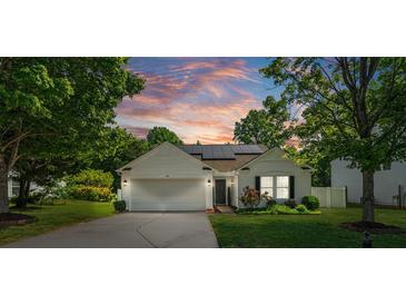 Charming single-story home with white siding, manicured lawn, and solar panels at sunset at 1961 Leesburg Dr, Clover, SC 29710