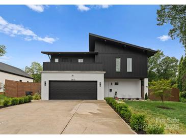 Striking modern home featuring a black and white exterior, clean lines, and well-manicured landscaping at 2913 Lake Ave, Charlotte, NC 28208