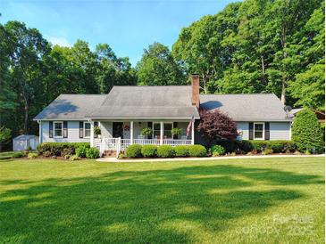 Charming home with a welcoming front porch and well-manicured lawn at 322 Killian Rd, Stanley, NC 28164