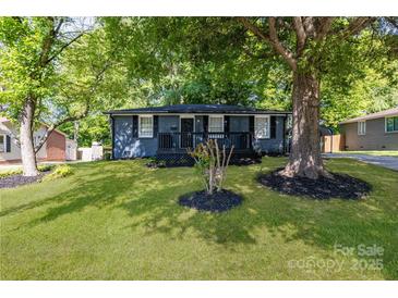 Charming blue house with inviting front porch and lush green lawn at 3637 Glenville Rd, Charlotte, NC 28215