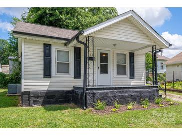 Charming single-story home featuring a cozy front porch and well-maintained landscaping at 520 E Maple Ave, Gastonia, NC 28054