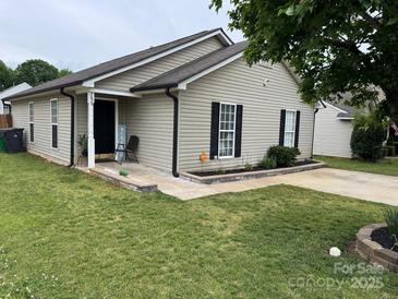 Charming single story home with neutral siding, black shutters, and a well-manicured lawn at 5804 Fairchase Ave, Charlotte, NC 28269