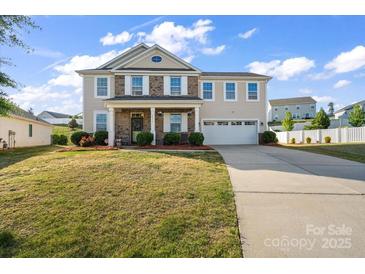 Charming two-story home with a brick facade, landscaped yard, and an attached two-car garage at 9533 Silverdale Ln, Charlotte, NC 28269