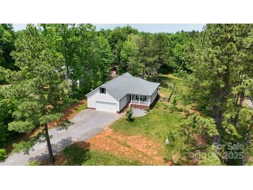 Charming home nestled among mature trees, with a large lawn and gravel driveway at 1406 High Shoals Rd, Lincolnton, NC 28092