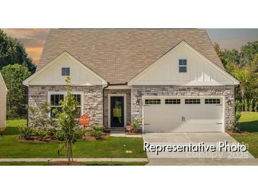 Charming single-Gathering home with stone accents, a two-car garage, and a well-manicured lawn at 1509 Autumn Banks Way # 4P, High Shoals, NC 28077
