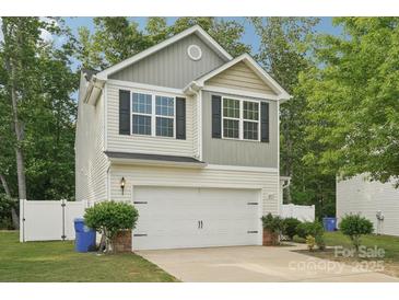 Charming two-story home with a white garage door, black shutters, and a well-manicured lawn at 1835 Allegheny Dr, Gastonia, NC 28054
