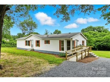 Charming single-story home with white siding, red shutters and a convenient accessibility ramp at 2002 Kingston Rd, Kingstown, NC 28150