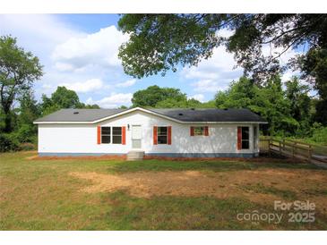 Charming single-story home with white siding, red shutters, and well-maintained front yard at 2002 Kingston Rd, Kingstown, NC 28150