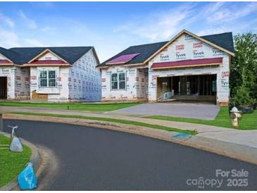 Street view of new construction homes with Tyvek wrap in a suburban neighborhood at 2085 Bonds Ln # 26, Fort Mill, SC 29715