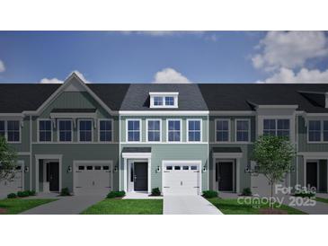 Charming townhome exterior features a garage and covered entrance with a beautiful blue-green facade at 2716 Lehigh Rd, Charlotte, NC 28208