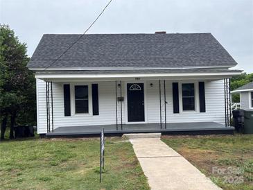 Charming single-story home with a covered front porch and a well-maintained lawn at 103 Meadow Ne Ave # 6, Concord, NC 28025