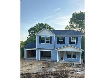 Two story house with two garages and light blue siding under a clear sky at 211 N Gregory St, Lancaster, SC 29720
