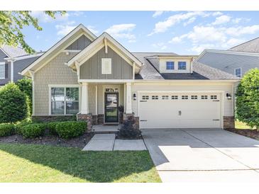 Charming single-Gathering home featuring a manicured lawn and an attached two-car garage at 214 Blossom Ridge Dr, Mooresville, NC 28117